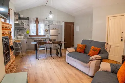 a living room with a couch and a table at Casa del patio in Villanueva de Valdueza