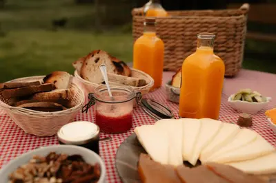 a picnic table with bread and bottles of orange juice at Mi Tesoro in Viveiro