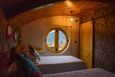 a bedroom with a bed and a round window at Mi Tesoro in Viveiro