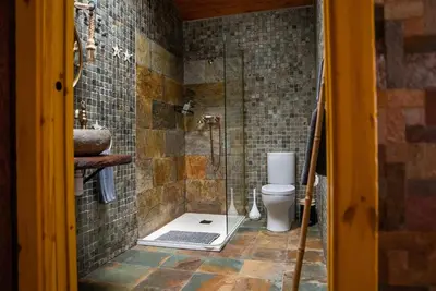 a bathroom with a shower with a toilet and a sink at Mi Tesoro in Viveiro