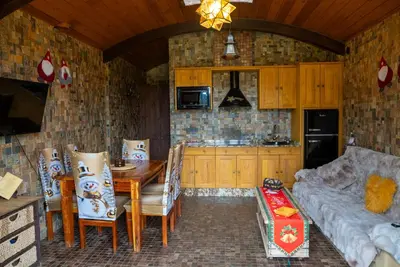 a kitchen with a table and chairs and a couch at Mi Tesoro in Viveiro