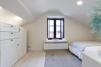 a bedroom with a bed and a window at Ático tipo loft en San Sadurniño. in Santa María La Mayor del Rosario