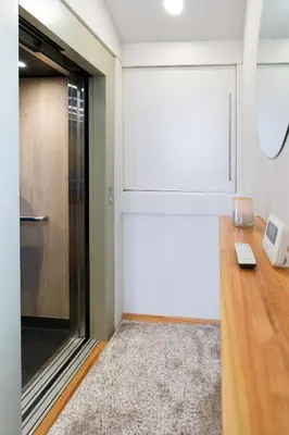 a sliding glass door in a room with a table at Ático tipo loft en San Sadurniño. in Santa María La Mayor del Rosario