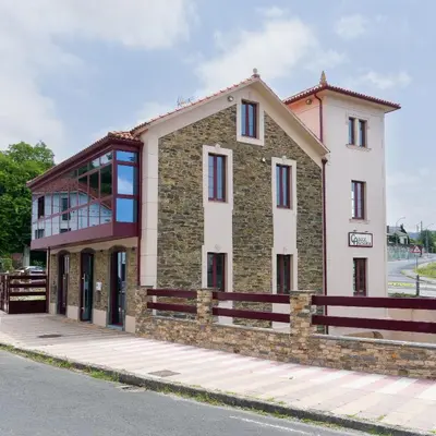 a building on the side of a street at Ático tipo loft en San Sadurniño. in Santa María La Mayor del Rosario