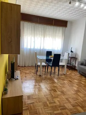 a living room with a table and chairs at Coqueto alojamiento cercano a las termas A in Ourense