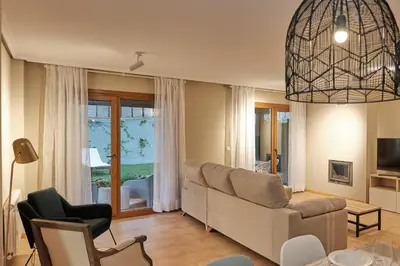 a living room with a couch and chairs and a window at Yuhom, casas con alma. Xacedos 3 in Miño