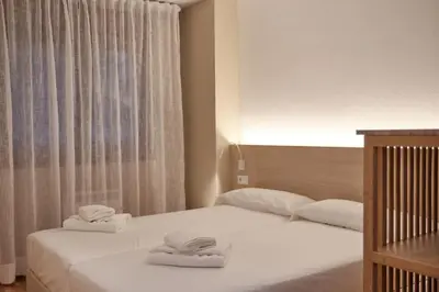 a bedroom with two beds with towels on them at Yuhom, casas con alma. Xacedos 3 in Miño