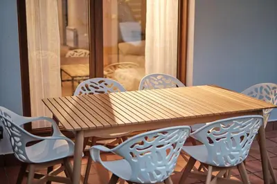 a wooden table with blue chairs around it at Yuhom, casas con alma. Xacedos 3 in Miño