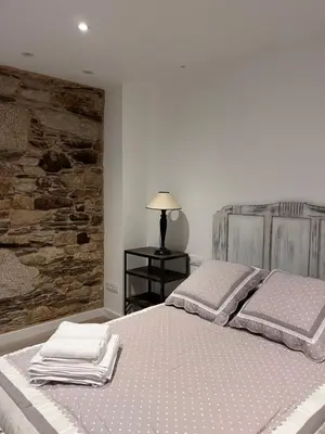 a bedroom with a bed with two towels on it at Caraxolas in Lugo