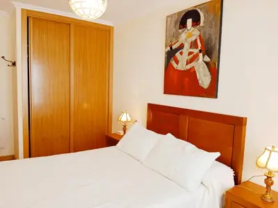 a bedroom with a bed and a painting on the wall at La Casa de Ana in Viveiro