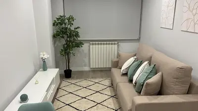 a living room with a couch and a table at Apartamentos Nature in Cangas del Narcea