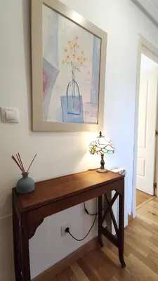 a table in a room with a picture on the wall at Alianza del Castillo in Ponferrada