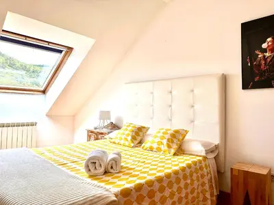 a bedroom with a bed with towels on it at Alianza del Castillo in Ponferrada