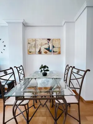 a dining room with a glass table and chairs at Alianza del Castillo in Ponferrada