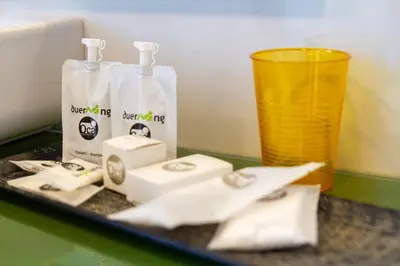 a counter with two bottles of soap and a glass at Duerming Ría de Viveiro in Viveiro