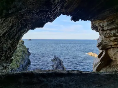 a view of the ocean from inside a cave at Duerming Ría de Viveiro in Viveiro