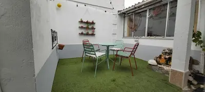 a table and chairs in a room with green grass at Quintana&lev in Viveiro