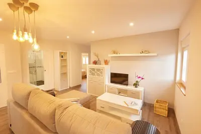 a living room with a couch and a tv at Quintana&lev in Viveiro