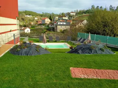 a backyard with a swimming pool and green grass at Casa de Sunny in Parada