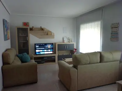 a living room with two couches and a flat screen tv at Tu Apartamento Ideal in Ponferrada