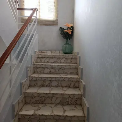 a staircase with a vase with a flower in it at Tu Apartamento Ideal in Ponferrada