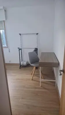 a table and a chair in a room at Casiña de Érika in San Cosme de Barreiros