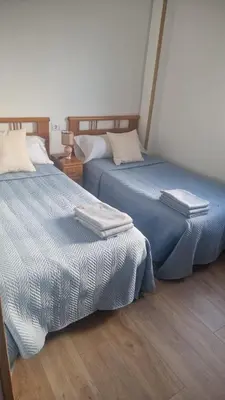 two beds sitting next to each other in a room at Casiña de Érika in San Cosme de Barreiros