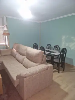 a living room with a couch and a table with chairs at Casiña de Érika in San Cosme de Barreiros