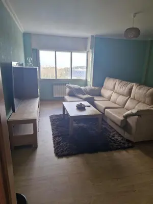 a living room with a couch and a coffee table at Casiña de Érika in San Cosme de Barreiros