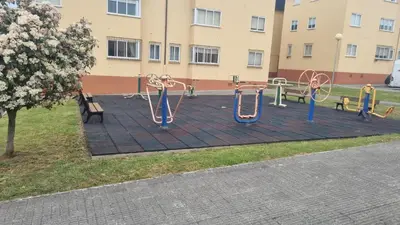 a playground in a park next to a building at Casiña de Érika in San Cosme de Barreiros