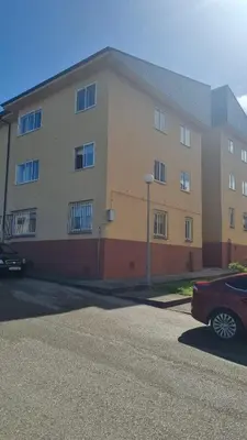 a building with a red car parked in front of it at Casiña de Érika in San Cosme de Barreiros