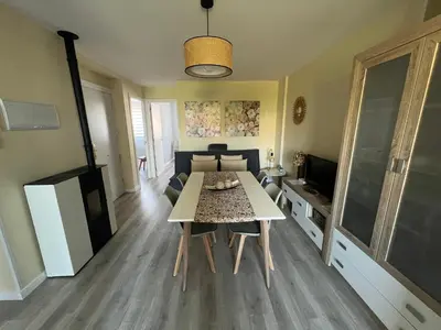 a living room with a table and a couch at Apartamento da Fraga in Arzúa