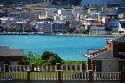 a view of a city with a large body of water at Ático con vistas a la ría y a Foz in Barreiros