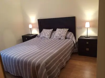a bedroom with a large bed with two night stands at Ático con vistas a la ría y a Foz in Barreiros