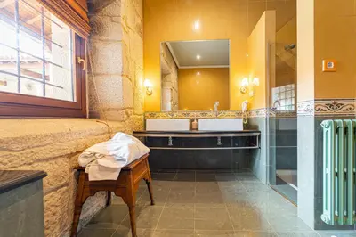 a bathroom with a sink and a mirror at Casa Rural Pazo San Damian in Amoeiro
