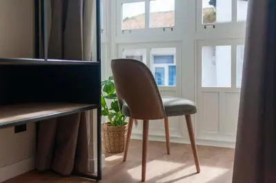 a chair sitting in front of a window at Albatros in Puentedeume