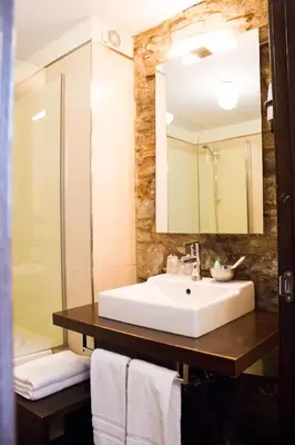 a bathroom with a sink and a mirror at Hotel A Tafona do Peregrino in Santiago de Compostela