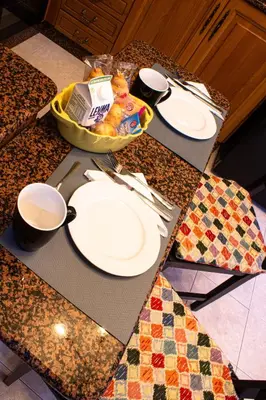 a table with white plates and utensils on a counter at Apartamento Alecrin Padrón in Padrón