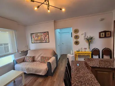 a living room with a couch and a table at Apartamento Alecrin Padrón in Padrón