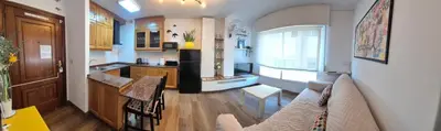 a kitchen with a couch and a table in a room at Apartamento Alecrin Padrón in Padrón