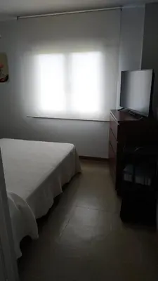 a bedroom with a bed and a dresser and a window at EnFOZ CONFORT Y RELAX in Foz