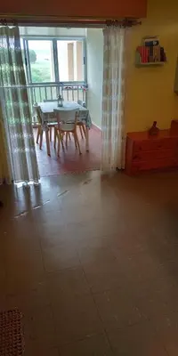 a living room with a table and a window at EnFOZ CONFORT Y RELAX in Foz