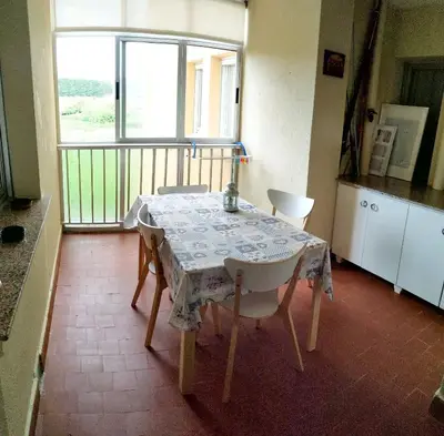 a table and chairs in a kitchen with a balcony at EnFOZ CONFORT Y RELAX in Foz