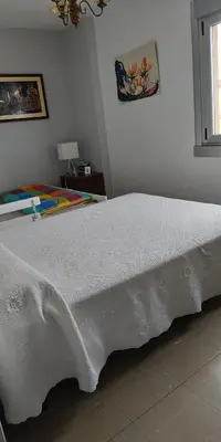a white bed in a bedroom with a window at EnFOZ CONFORT Y RELAX in Foz