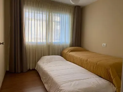 a bedroom with two beds and a window at Río, mar y montaña in Puentedeume