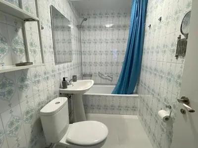 a bathroom with a toilet and a sink and a tub at Río, mar y montaña in Puentedeume
