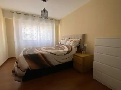 a small bedroom with a bed and a window at Río, mar y montaña in Puentedeume