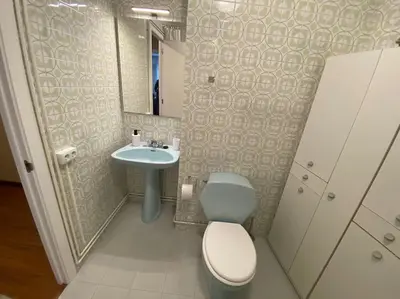 a bathroom with a toilet and a sink at Río, mar y montaña in Puentedeume