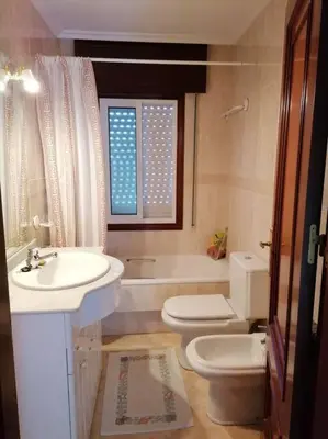 a bathroom with a sink and a toilet and a tub at O Lar do Suso in Refojos