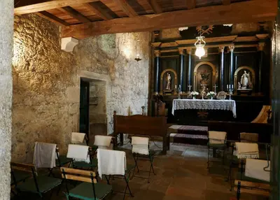 a room with chairs and a piano in a building at Hotel Pazo de Bieite in Boimorto